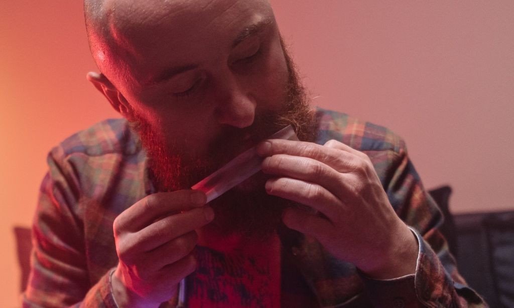 Licking joint after rolling it